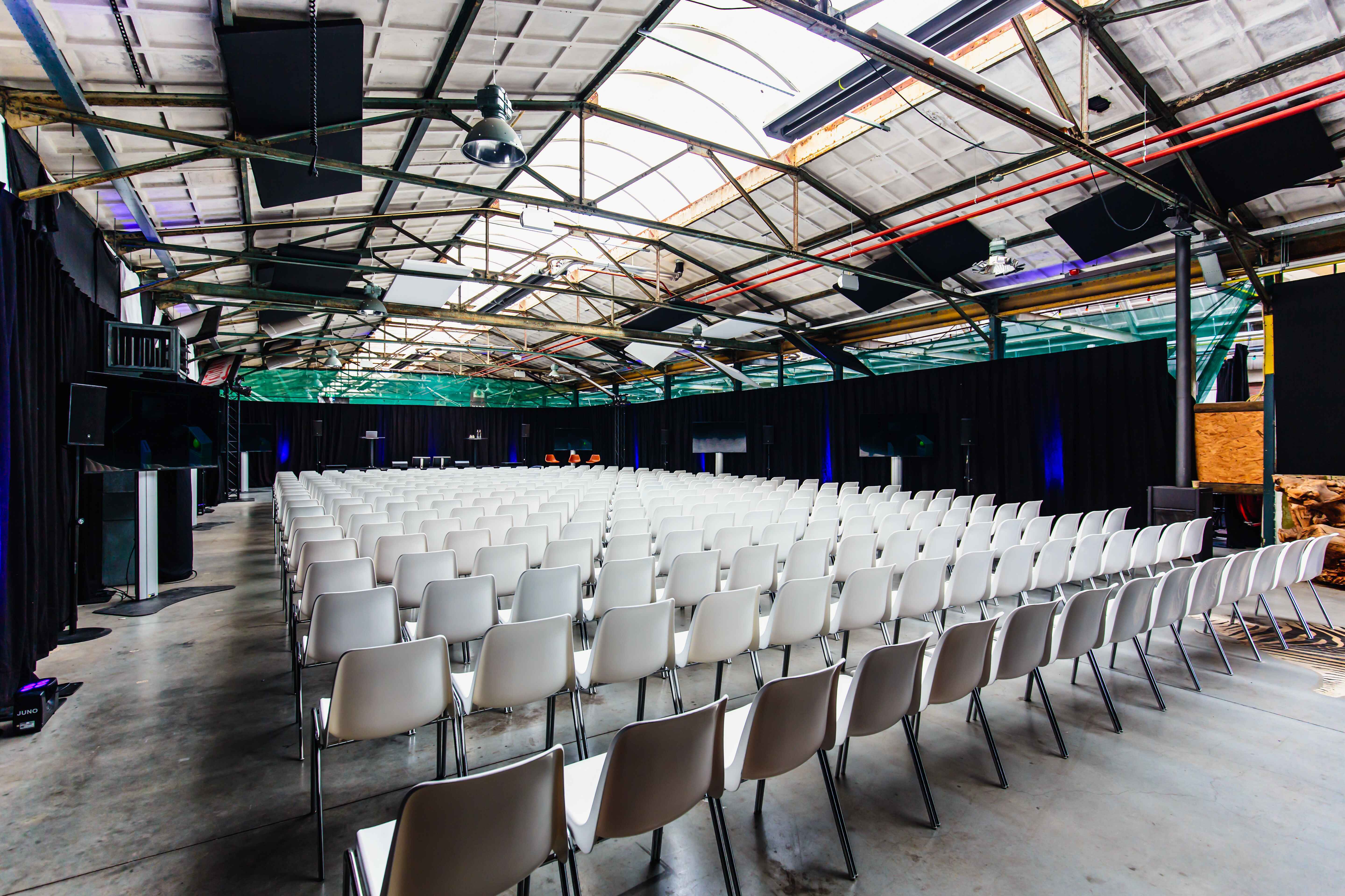 The Marketplace - plenary box setting 1 "Yada Yada event space at Taets Art and Event Park in Amsterdam and Zaandam, an industrial venue perfect for weddings, conferences, dinners, dance events, and more, set in a historic munitions factory."